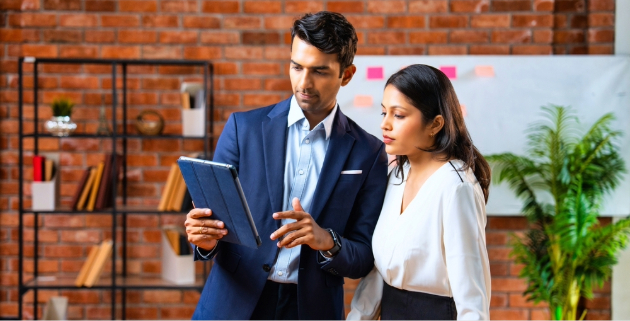 woman and man in office looking at tablet
