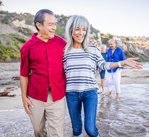 Mature couple walking in the water.