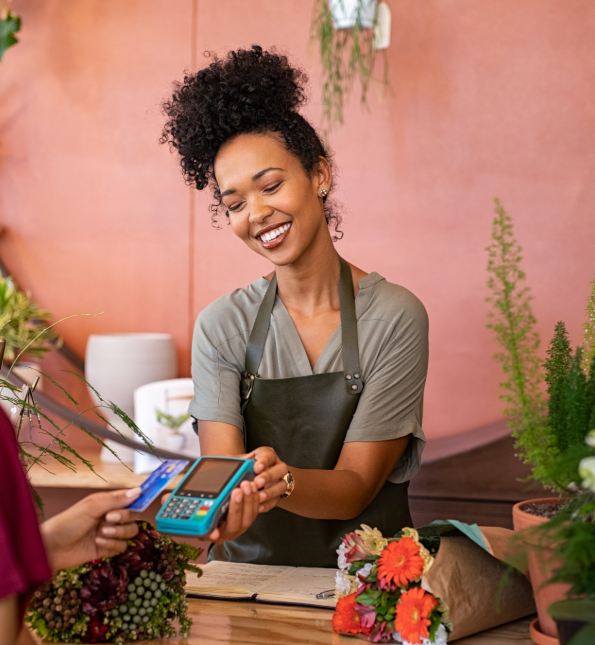 florist holding tap to pay device