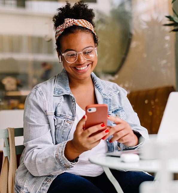 Woman looking at her phone at a coffee shop