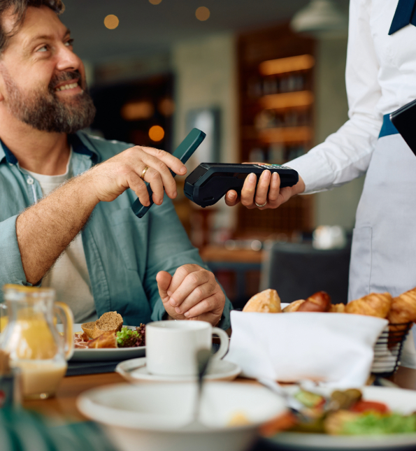 restaurant customer using phone to tap to pay