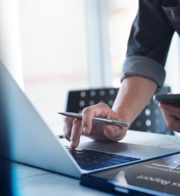 person holding pen using mobile device