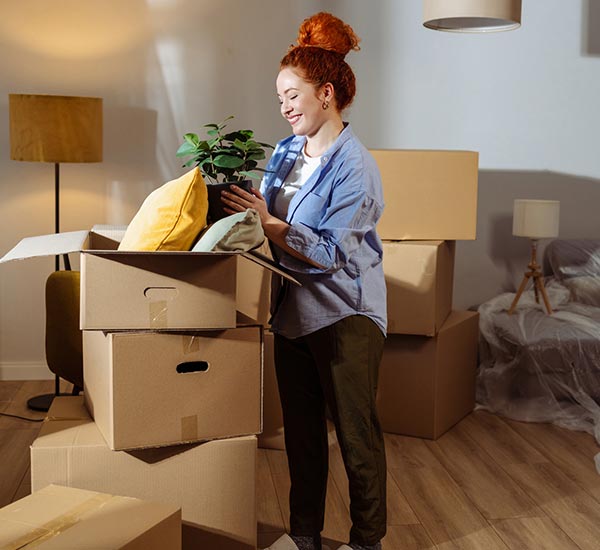 Woman unpacking boxes in new home