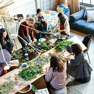 A group of people making wreaths